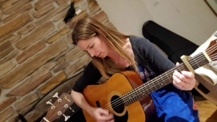Jenn playing guitar