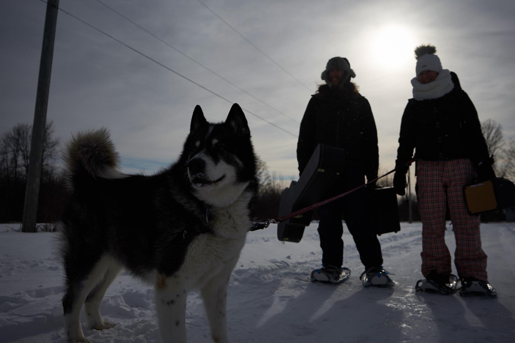 Jenn Matt and Shadow with music gear in snowy field