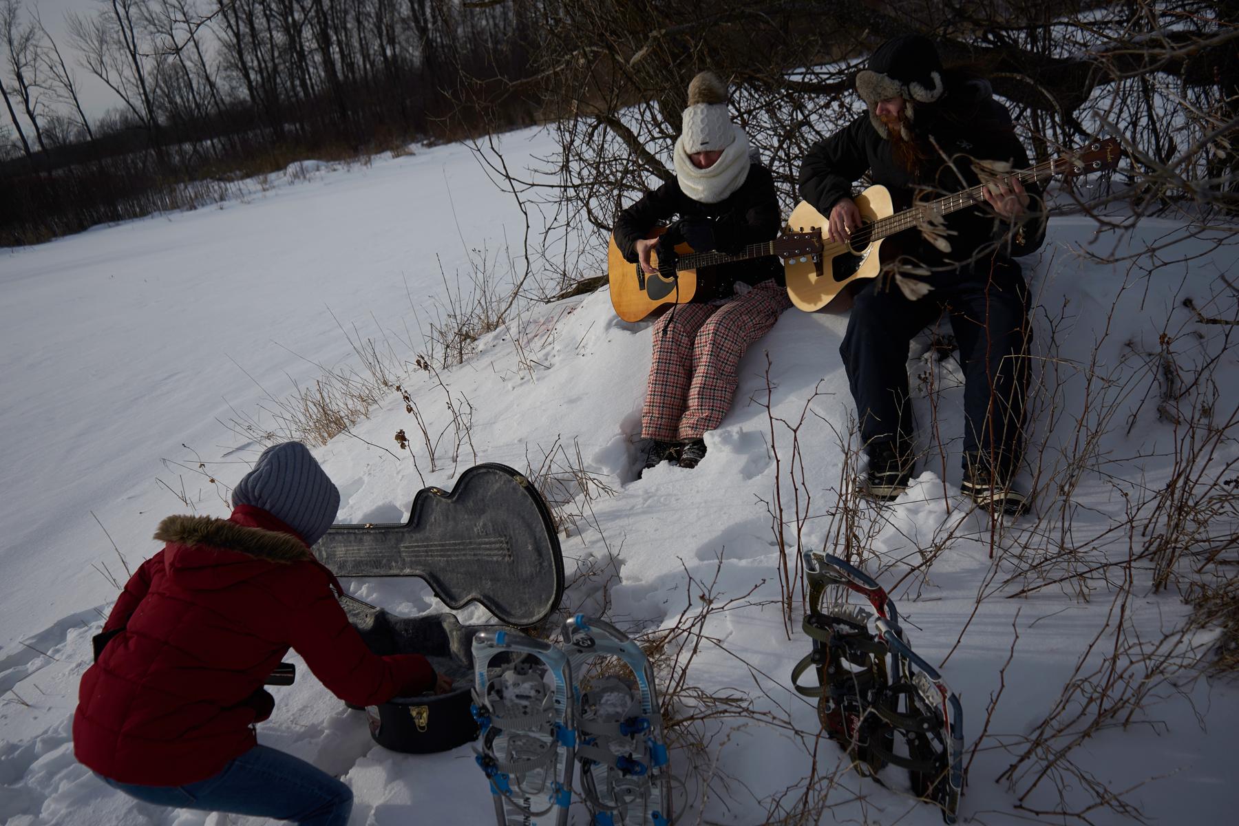 Zoey putting money in guitar case while we busk in the snow