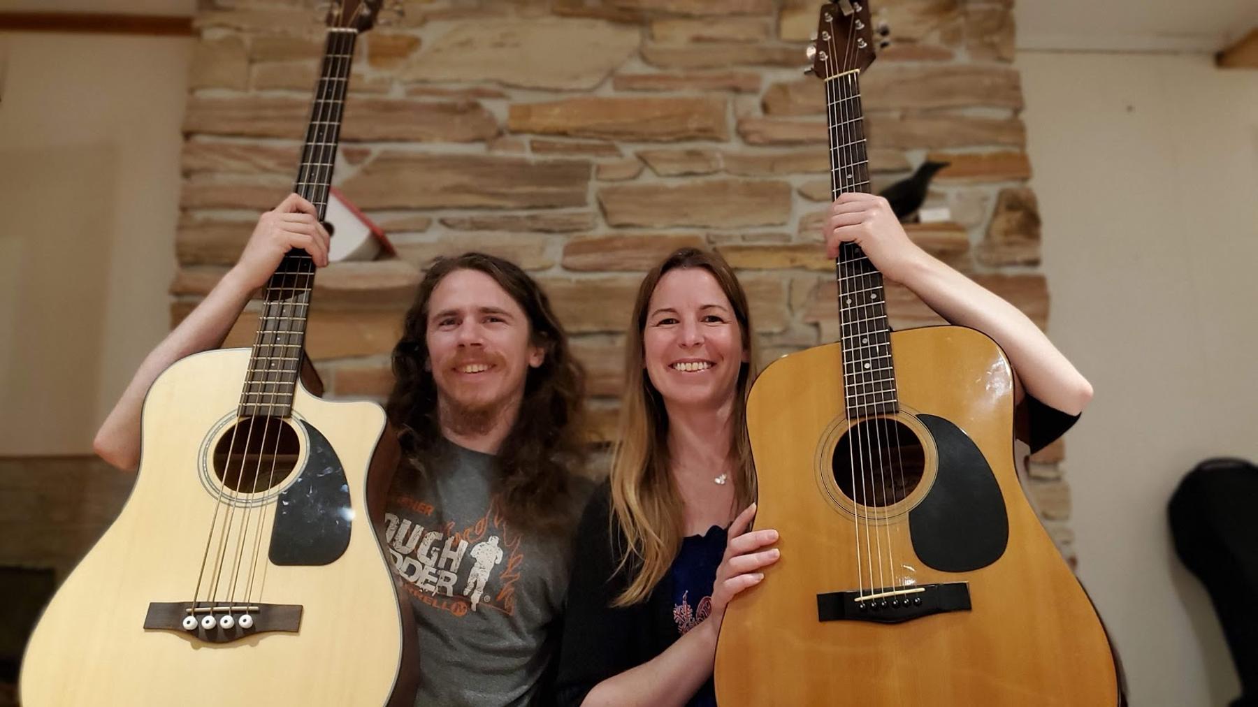 Jenn and Matt smiling with their instruments