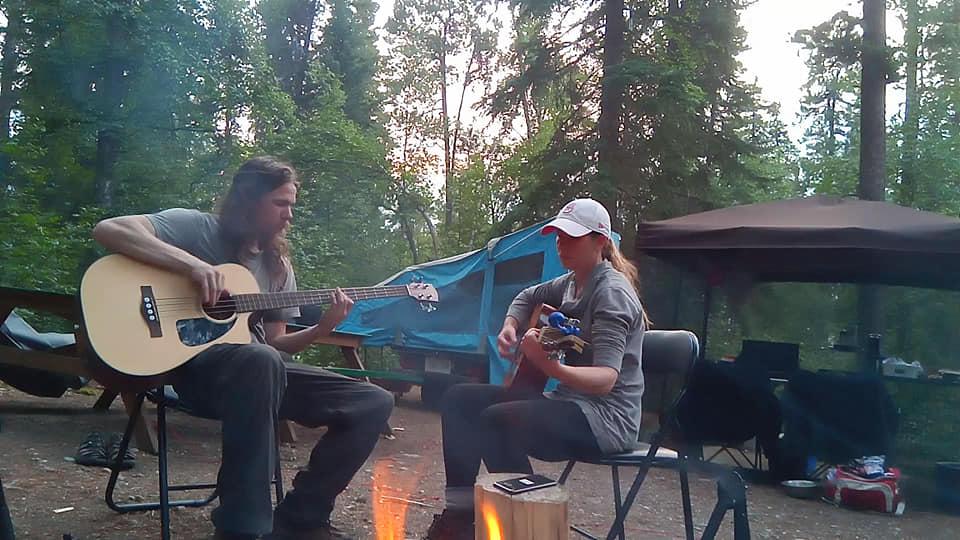 Jenn and Matt jamming at a campfire