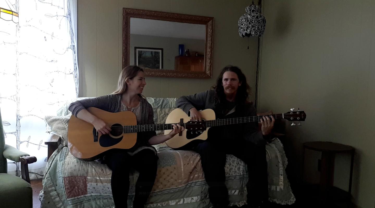 Jenn and Matt jamming on a couch