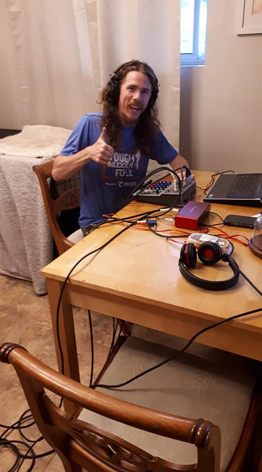 Matt giving a thumbs up beside a mixing board